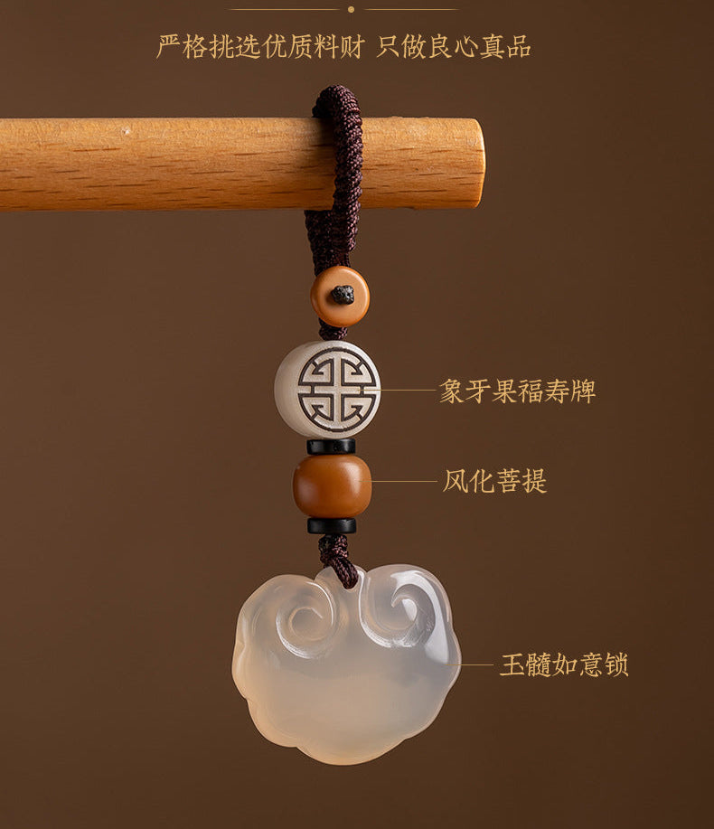 Decorative pendant with beads on a wooden stick against a brown background