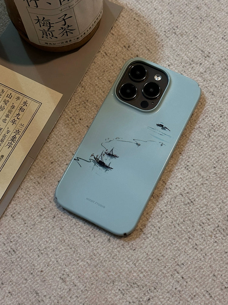 A green phone case with a nature-inspired design, displayed on a surface near a bottle and some documents, showing signs of wear.