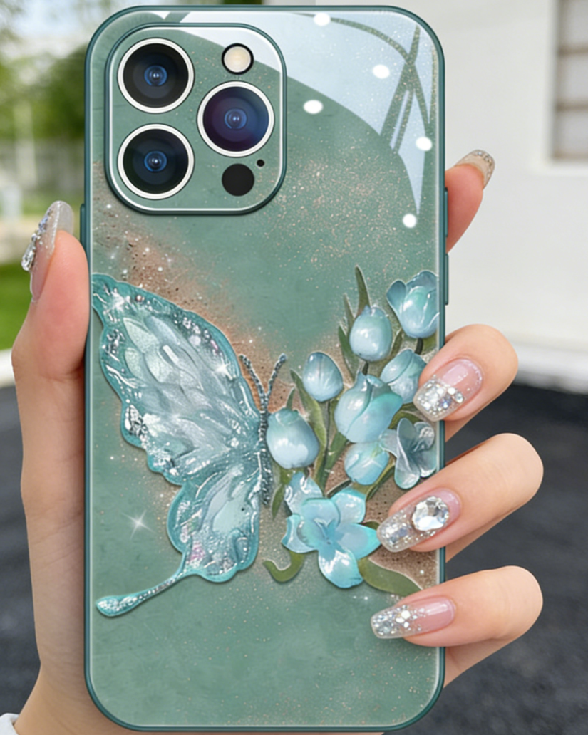 Phone case with butterfly and floral design held by a hand with glittery nails.