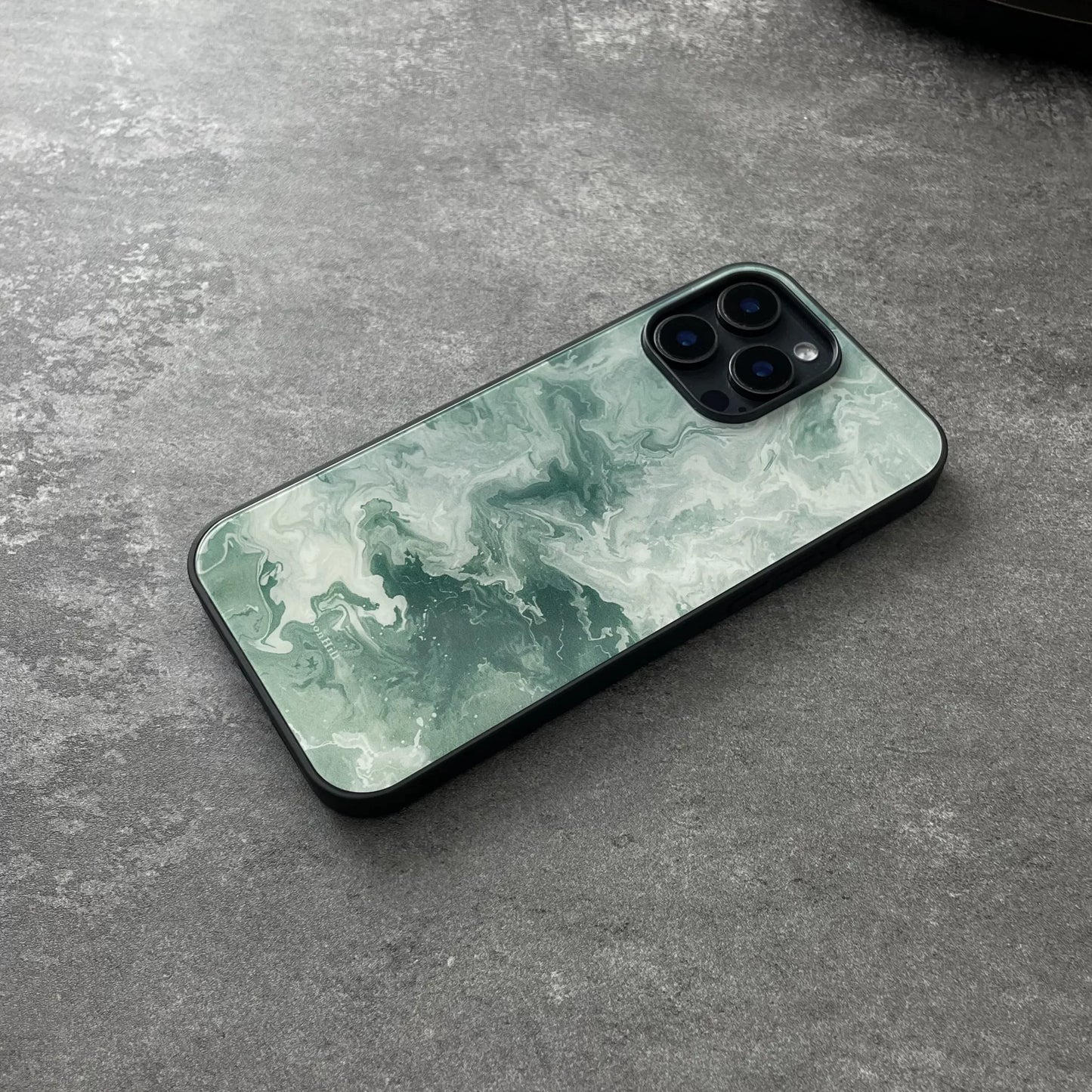 Green wavy pattern anti-slip full-coverage glass phone case with a premium feel.