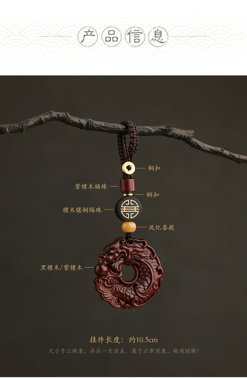 Decorative pendant with intricate design on a branch against a dark background