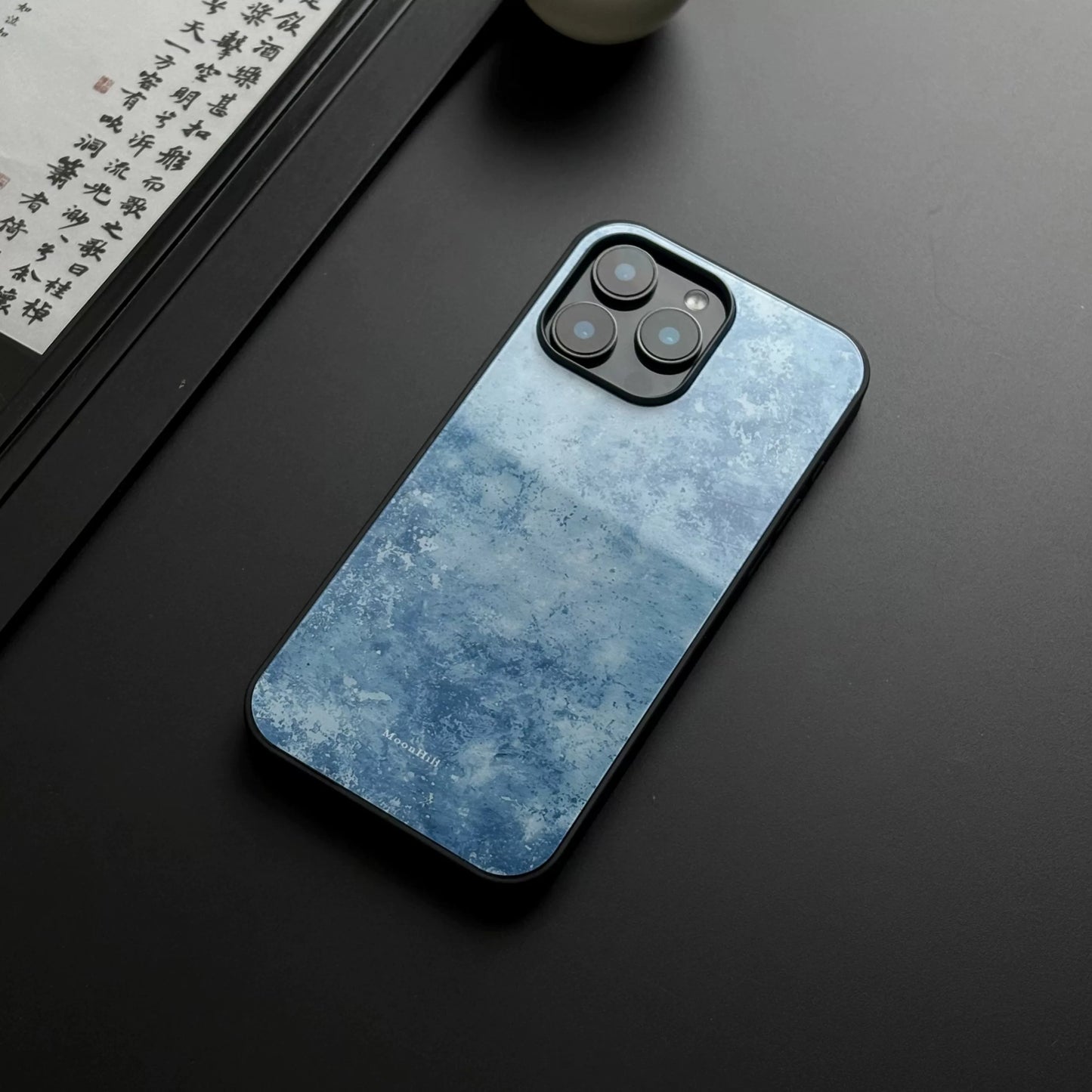 Blue frosted anti-slip full-coverage glass phone case with a premium feel.
