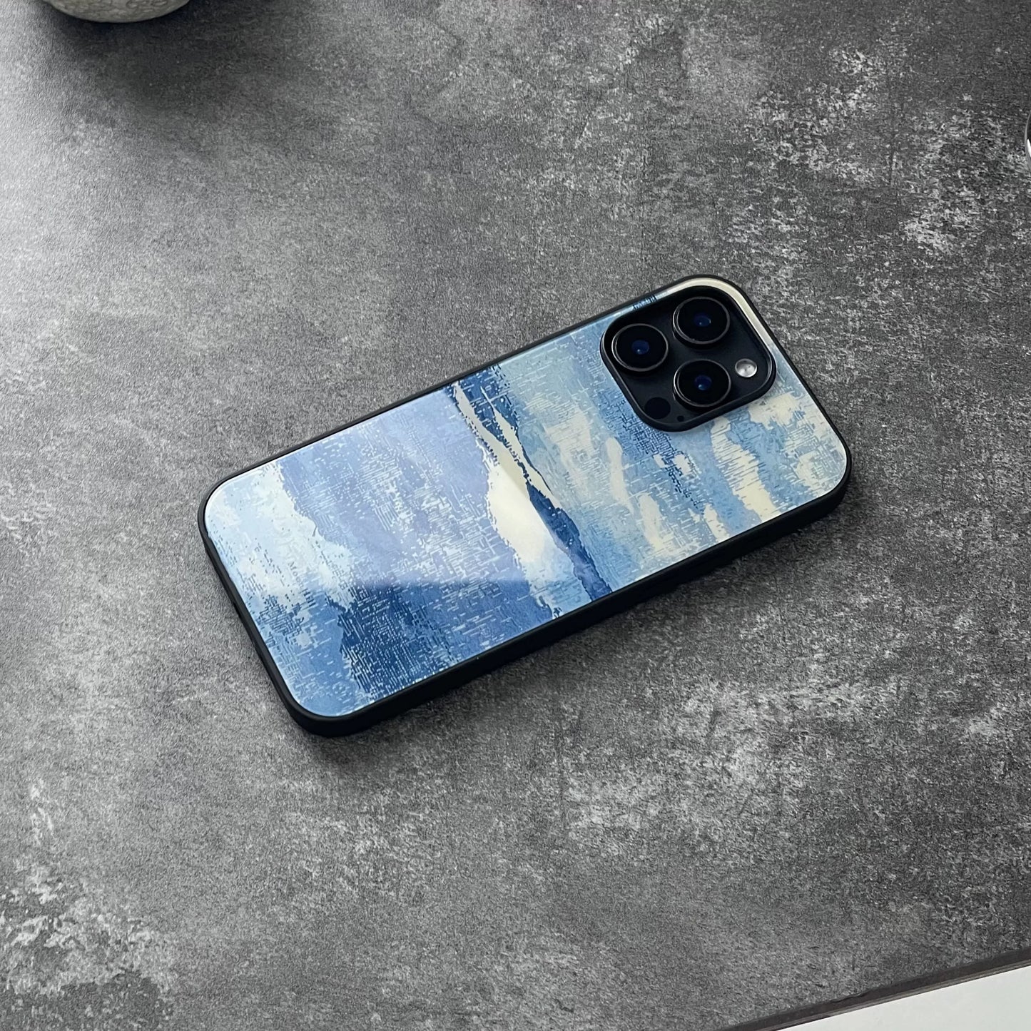Blue and white, fully enclosed glass phone case with an original, high-end design