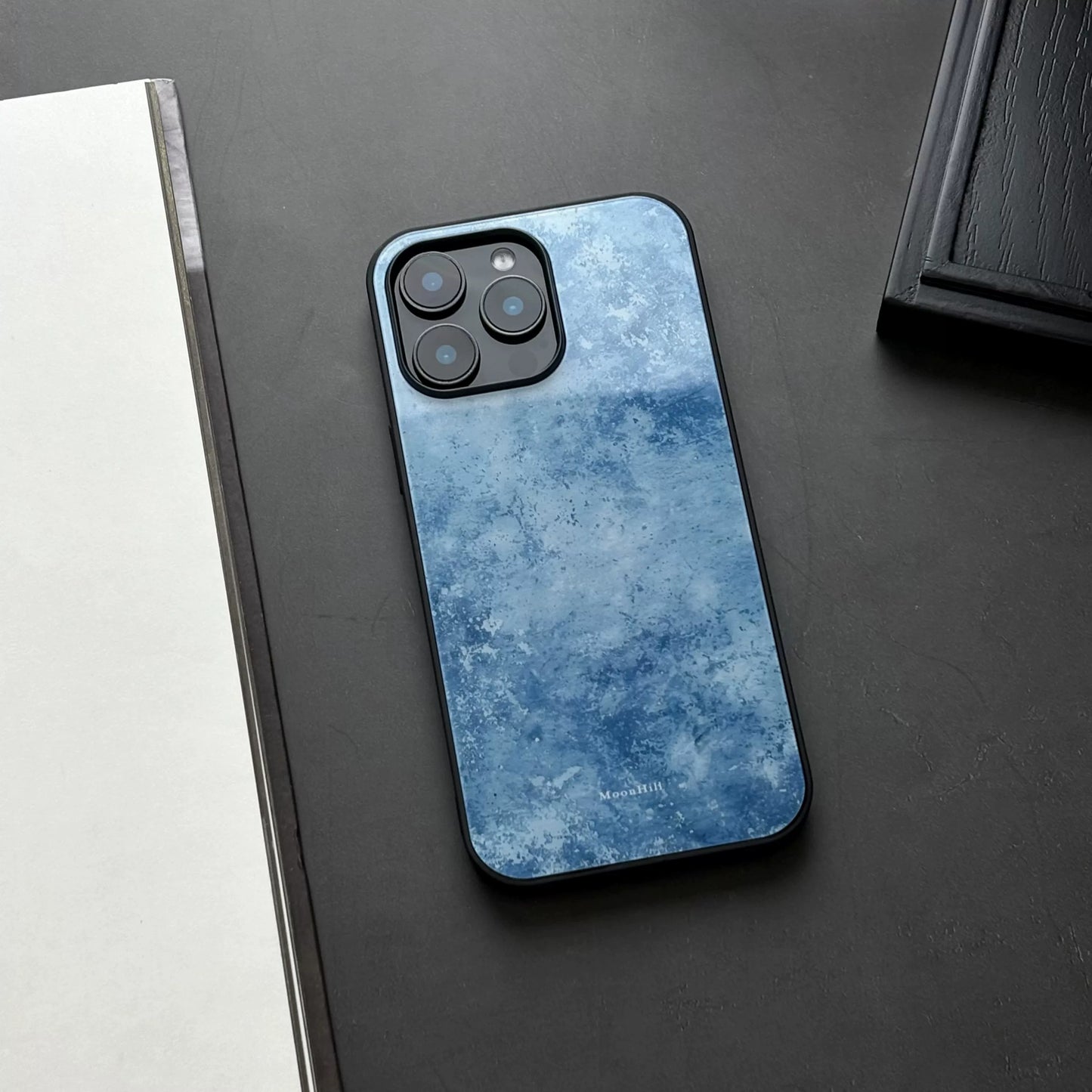 Blue frosted anti-slip full-coverage glass phone case with a premium feel.