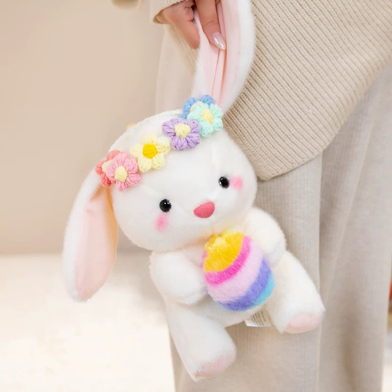 Easter bunny plush toy holding easter eggs and roses