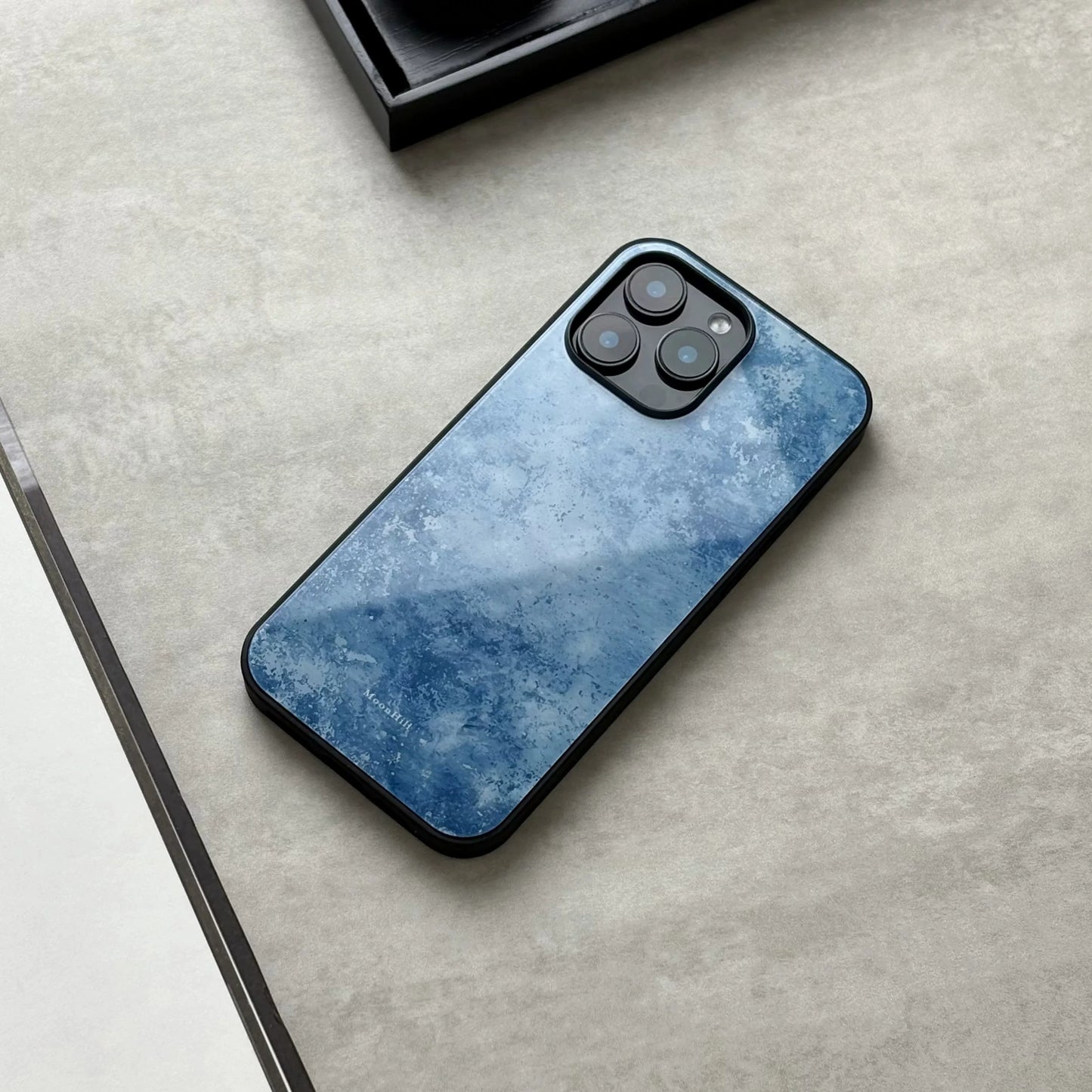 Blue frosted anti-slip full-coverage glass phone case with a premium feel.
