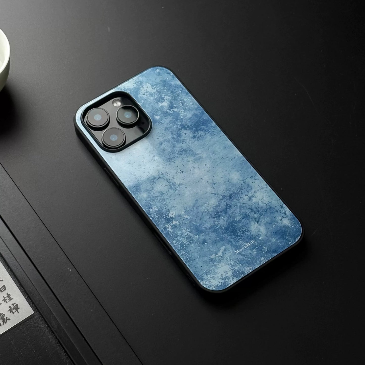 Blue frosted anti-slip full-coverage glass phone case with a premium feel.