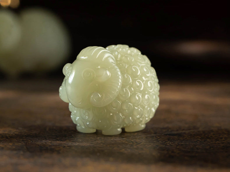 White jade sheep figurine on a dark surface with Chinese text