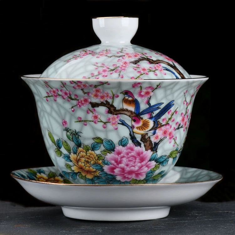 Intricately painted porcelain tea cup with saucer, showcasing vivid pink blossoms.
