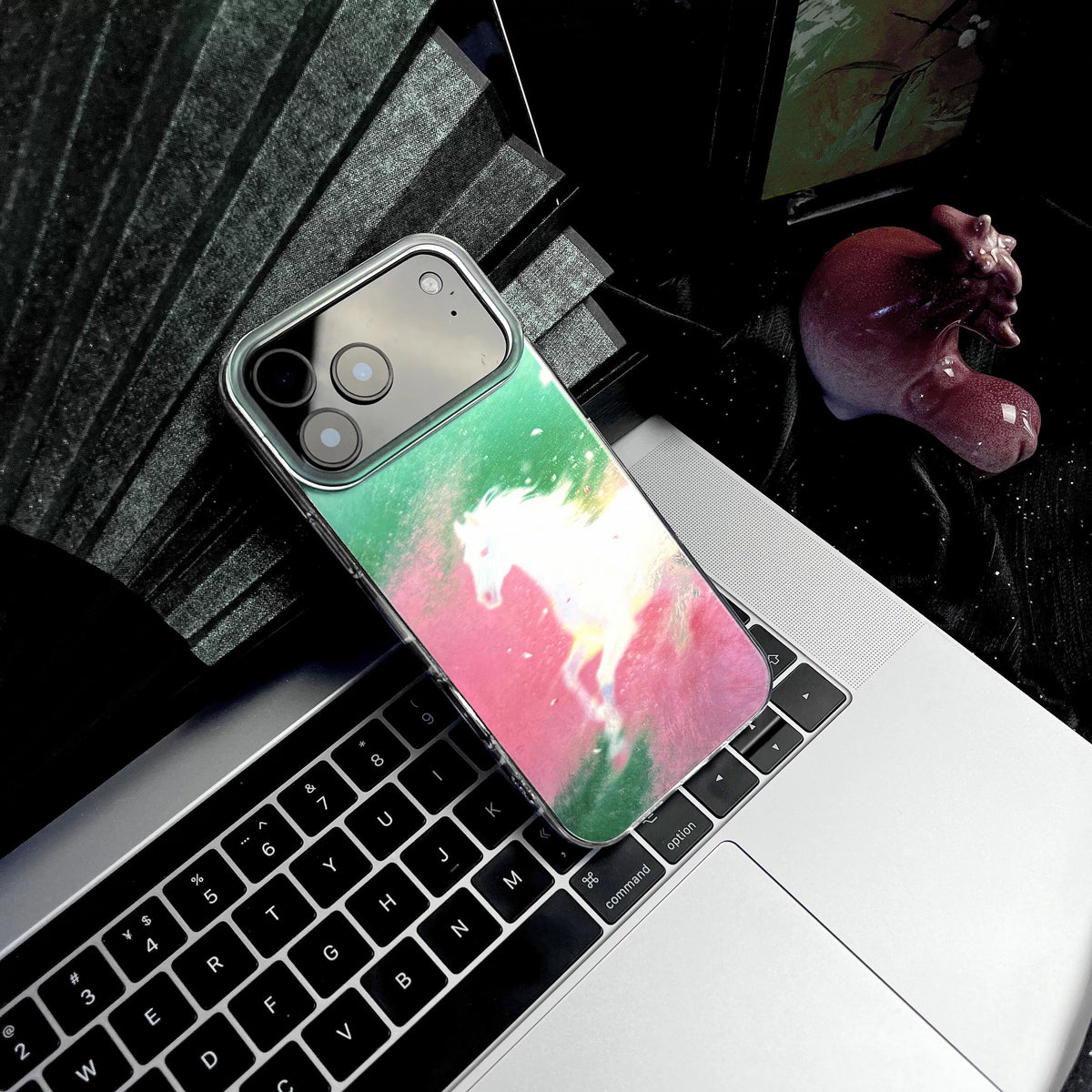 Phone case with a colorful design on a laptop keyboard