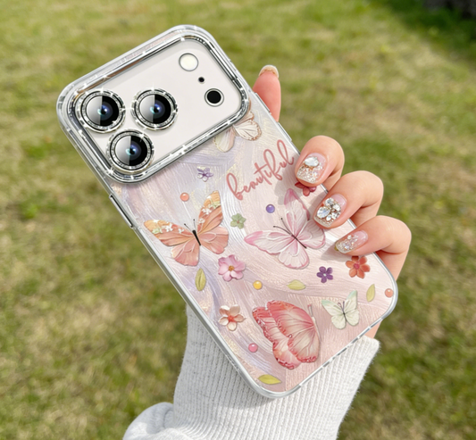 Phone case with butterfly design held by a person outdoors