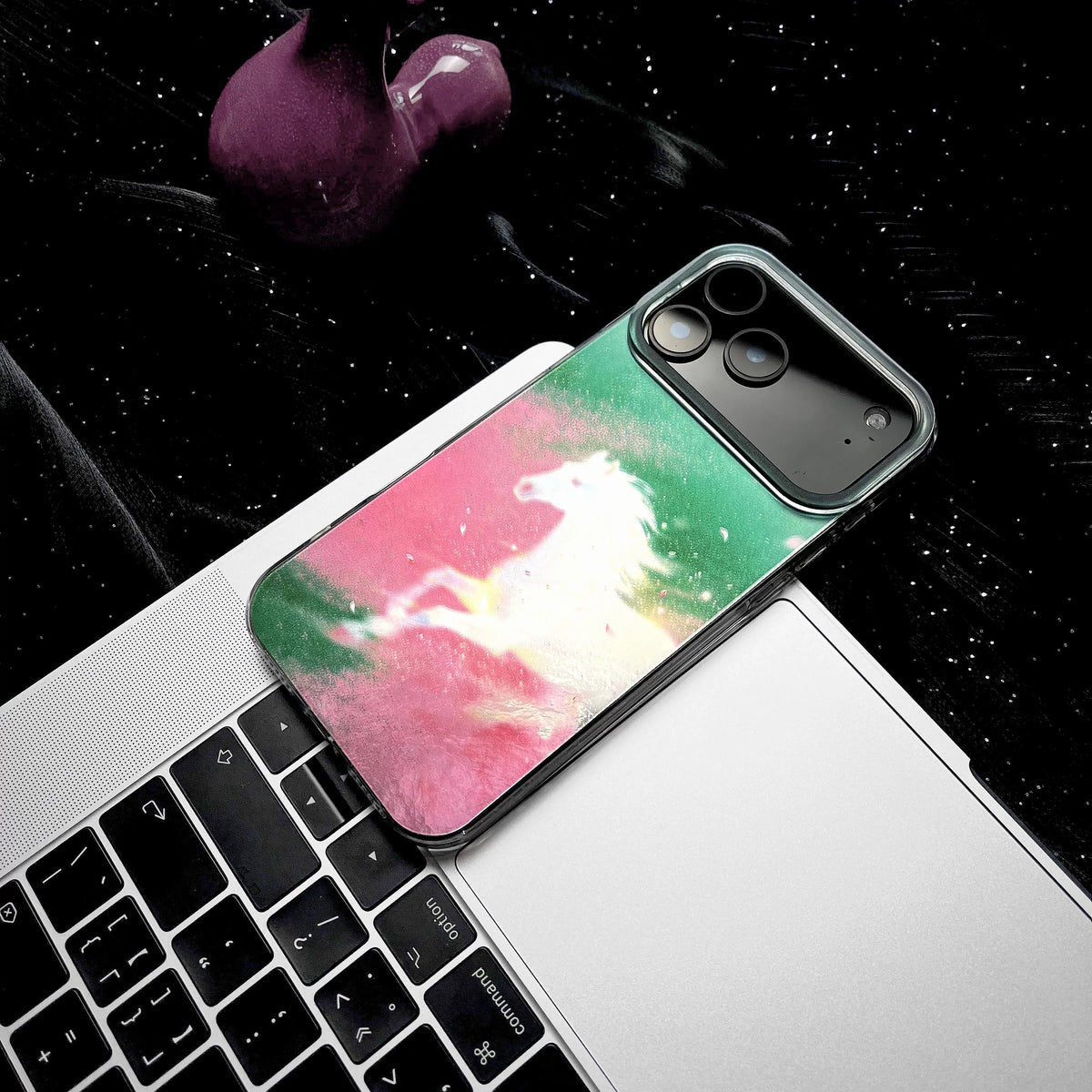 Phone case with unicorn design on a laptop