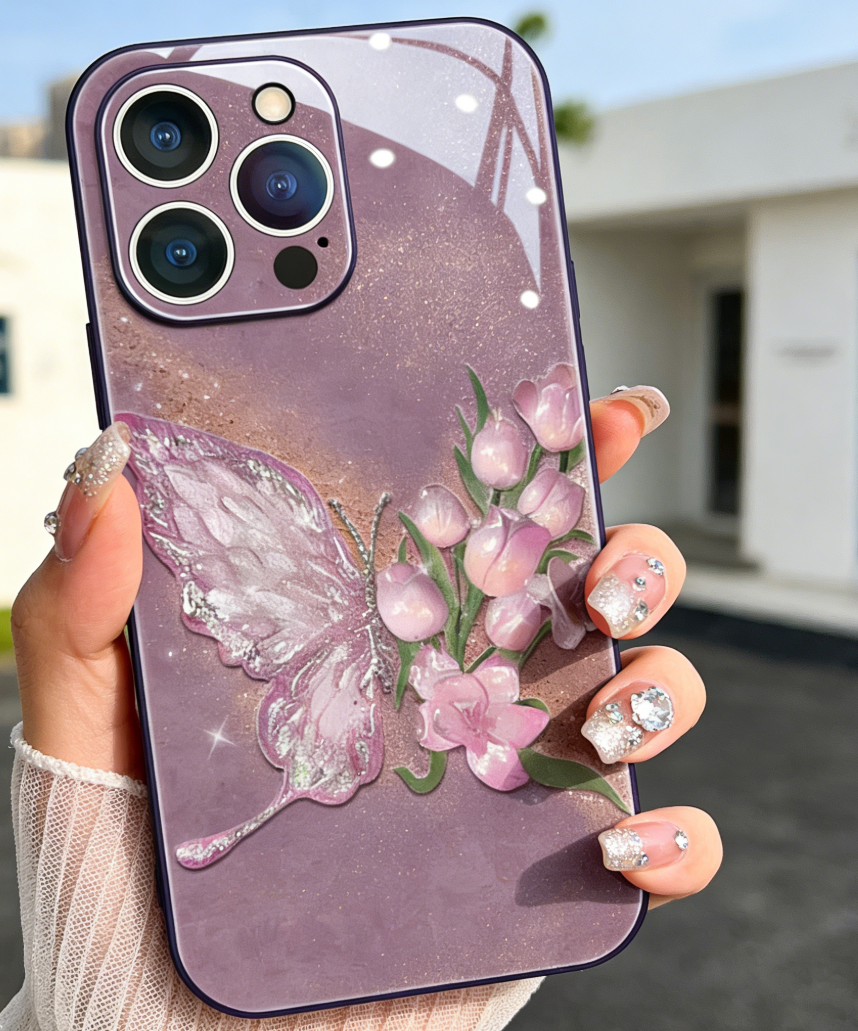 Phone case with butterfly and floral design held by a hand with decorated nails.
